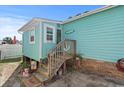 Quaint teal home with wooden steps and welcoming decor at 703 3Rd Ave. S, North Myrtle Beach, SC 29582