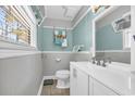 Cozy bathroom featuring a single sink vanity, neutral wall paint and trim, and tile flooring at 789 University Forest Circle, Conway, SC 29526