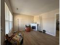 Bright living room featuring wood floors, a fireplace, and large windows for natural light at 10 Buckthorn St., Andrews, SC 29510
