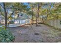 Spacious backyard with wooden fence and large trees at 101 Bent Tree Ln., Pawleys Island, SC 29585