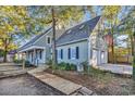 Two-story house with gray siding, double garage, and American flag at 101 Bent Tree Ln., Pawleys Island, SC 29585