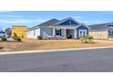 Two-story house with gray and blue siding, landscaped yard at 109 Foxford Dr., Conway, SC 29526