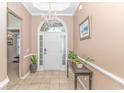 Bright and spacious foyer with tile floors and elegant chandelier at 113 Barn Owl Ct., Carolina Shores, NC 28467