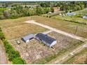 Aerial shot of a single-story home with a long driveway, featuring an outbuilding and spacious lot at 122 Willie Mays Pl., Aynor, SC 29511