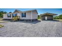 Gray manufactured home with attached carport and gravel driveway at 122 Willie Mays Pl., Aynor, SC 29511