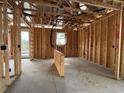 Interior framing of a room showing the studs, electrical wiring, window, and exterior door at 1245 Lady Bird Way, North Myrtle Beach, SC 29582