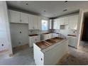 White kitchen with an island and plenty of cabinet space at 1253 Lady Bird Way, North Myrtle Beach, SC 29582