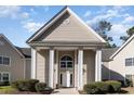 Building entrance with columns and a white door at 1350 Mcmaster Dr. # C, Myrtle Beach, SC 29575