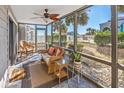 Relaxing screened porch with wicker furniture, ceiling fan, and ocean view at 1820 N Ocean Blvd. # 102D, North Myrtle Beach, SC 29582