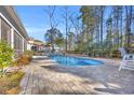 Inviting kidney-shaped pool with brick patio and lush landscaping at 2560 Ellerbe Circle, Myrtle Beach, SC 29588