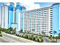 View of the Caribbean Resort & Villas building from the street, showing parking and landscaping at 3000 N Ocean Blvd. # 333, Myrtle Beach, SC 29577