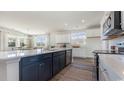 Open concept kitchen with island, white cabinets, and a mix of dark and light colors at 398 Glacier Way, Conway, SC 29526