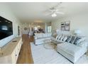 Living room with L-shaped sectional sofa and hardwood floors at 4881 Dahlia Ct. # 101, Myrtle Beach, SC 29577