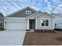 New construction home with gray siding, white garage door, and teal front door at 5439 Shelly Lynn Dr., Myrtle Beach, SC 29579