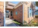 Brick facade with walkway, entry door, and landscaping at 5808 Bridlewood Rd., North Myrtle Beach, SC 29582