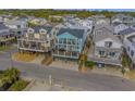 Elevated view of teal house amongst other beach homes at 6001 - E8 S Kings Hwy., Myrtle Beach, SC 29575