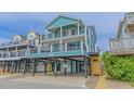 Two-story teal home with elevated deck and garage underneath at 6001 - E8 S Kings Hwy., Myrtle Beach, SC 29575