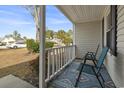 Relaxing front porch with two teal chairs and a patterned rug at 603 Plantation Dr., Surfside Beach, SC 29575