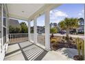 Covered front porch with white columns and railing, overlooking the neighborhood at 692 Cherry Blossom Dr., Murrells Inlet, SC 29576