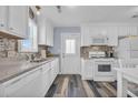 White kitchen with stainless steel appliances and tile backsplash at 820 9Th Ave. S, North Myrtle Beach, SC 29582