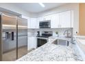 Modern kitchen features stainless steel appliances and white cabinets at 1100 Possum Trot Rd. # H234, North Myrtle Beach, SC 29582