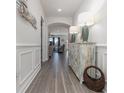 Bright entryway with hardwood floors, decorative console table, and access to living room at 1204 Passante Ave., Myrtle Beach, SC 29572