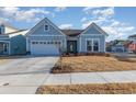Newly built home with light blue siding, two-car garage, and well-maintained lawn at 1204 Passante Ave., Myrtle Beach, SC 29572
