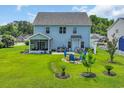 Expansive backyard features lush lawn, outdoor seating and fire pit perfect for outdoor entertaining at 1213 Pineridge St., Conway, SC 29527