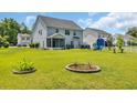 Spacious backyard with manicured lawn, patio, and cozy firepit area perfect for outdoor gatherings at 1213 Pineridge St., Conway, SC 29527