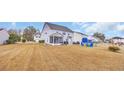 Expansive backyard featuring a screened porch, patio, and ample space for outdoor activities at 1213 Pineridge St., Conway, SC 29527