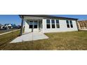 Backyard featuring a concrete patio and large windows for natural light at 1300 Crested Iris Way, North Myrtle Beach, SC 29582
