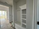 Bright entryway with a built-in storage bench and coat hooks at 1300 Crested Iris Way, North Myrtle Beach, SC 29582