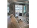 Inviting living room with stylish furnishings, modern decor, and access to a sun room with outdoor views at 1310 Beautyberry Way, North Myrtle Beach, SC 29582