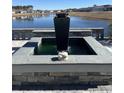 An outdoor living space with a pond view that features a modern fountain at 1310 Beautyberry Way, North Myrtle Beach, SC 29582