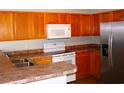Kitchen with wood cabinets, stainless steel appliances, and double sink at 148 Junco Circle, Longs, SC 29568