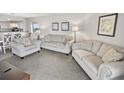 Spacious living room with comfortable seating and partial kitchen view at 201 74Th Ave. N # 701, Myrtle Beach, SC 29572
