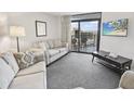 Bright living room with balcony access and ocean views at 201 74Th Ave. N # 701, Myrtle Beach, SC 29572