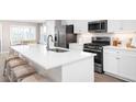 Modern kitchen with white cabinets, stainless steel appliances and island at 2347 Elowen Ln. # 11B, Longs, SC 29568