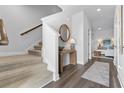 Bright entryway with carpeted stairs, wood floors, and a stylish console table at 253 Sandridgebury Dr. # 59, Little River, SC 29566