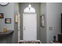 Bright entryway with a white door, arch window, and gray walls at 265 Encore Circle, Myrtle Beach, SC 29579