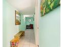 Hallway with light green walls, decorative artwork, and a bench, guiding to the interior at 2701 South Ocean Blvd. # 1711, North Myrtle Beach, SC 29582