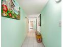 Light green hallway featuring tiled floors and decorative wall art, leading to other rooms at 2701 South Ocean Blvd. # 1711, North Myrtle Beach, SC 29582