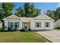 House exterior with teal shutters, landscaping, and a driveway at 3348 Merganser Dr., Conway, SC 29527