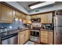 Well-equipped kitchen with light wood cabinets and stainless steel appliances at 400 N Waccamaw Dr. # 304, Garden City Beach, SC 29576
