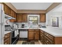 Cozy kitchen with wood cabinets, white countertops, and standard appliances at 409 77Th Ave. N # B, Myrtle Beach, SC 29572