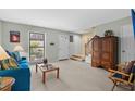Bright living room with comfy blue sofa and wood accents at 409 77Th Ave. N # B, Myrtle Beach, SC 29572
