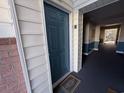 Entrance to a unit with a blue door, unit 'E' signage, welcome mat, and tiled floor hallway at 4273 Santolina Way # E, Murrells Inlet, SC 29576