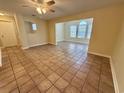 Bright living room featuring tile flooring, natural light, ceiling fan, and neutral walls at 4273 Santolina Way # E, Murrells Inlet, SC 29576