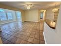 Open-concept living room featuring tile flooring, neutral walls, ceiling fan, and abundant natural light at 4273 Santolina Way # E, Murrells Inlet, SC 29576