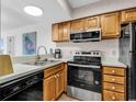 Updated galley kitchen features modern appliances, oak cabinets and neutral countertops at 4560 Greenbriar Dr. # 102-B, Little River, SC 29566